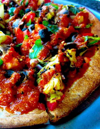A loaded veggie pie on the Italian Herb crust, with Tuscan Marinara sauce. My toppings consisted of minced garlic, spinach, artichokes, mushrooms, pineapples, red onions, banana peppers, black olives, red bell peppers and diced tomatoes. After the pizza was cooked, it was topped with fresh basil and a drizzle of tomato basil sauce. 